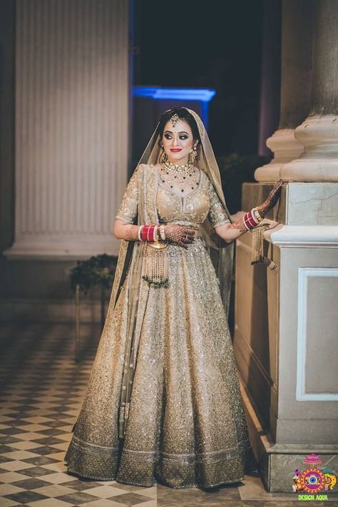 Gorgeous shimmer gold bridal lehenga for wedding. See more on wedmegood.com  #wedmegood #indianwedding #indianbride #lehenga #lehengacholi #bridallehenga #bridallehengacholi #shimmer #shimmerandshine #golden #goldenlehenga #jewellery #jewelry Golden Bridal Lehenga, Lehenga For Wedding, Golden Lehenga, Elegant Bridal Dress, Indian Wedding Bride, Latest Bridal Lehenga, Sabyasachi Lehenga, Wedding Lehenga Designs, Wedding Saree Collection