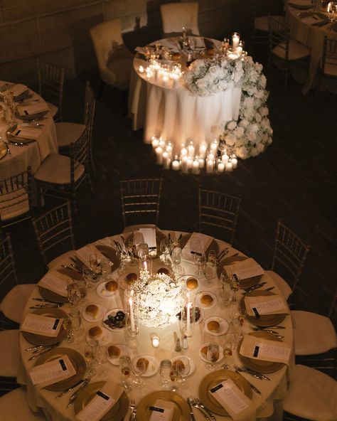 Playing around with shapes and textures🤍 Even a simple color scheme like this one can be made unique with rounded centerpieces, airy layouts of flowers, and combinations other various flowers that add to the beauty! These floral arrangements filled the space beautifully by accentuating the round tables and tall ceilings, making the decorations appear just how the couple and we anticipated! To find out more, schedule a wedding consultation by calling or texting as at (215)437-1913 We look f... Round Table Low Centerpieces, Wedding Round Table Candles, Wedding Reception Circle Tables, Round Table Wedding Set Up, Round Table Flower Arrangements, Circle Table Centerpiece, Circle Wedding Table Decor, Round Table Wedding Centerpieces, Circle Table Wedding Decor