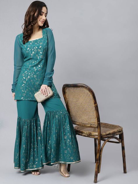 Add a few sparse accessories to finish the look. (1 Top/1 Bottom) Printed Sharara, Ethnic Suit, Minimal Accessories, Teal Fabric, Sharara Set, Festival Tops, Gold Print, Work Fashion, Fit Flare Dress