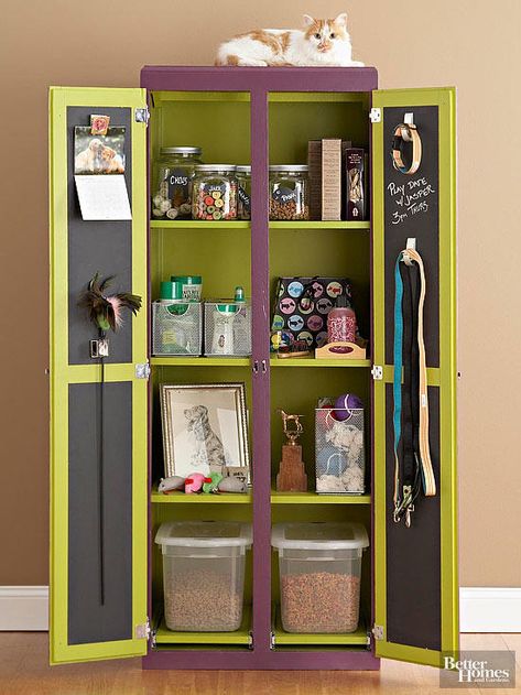 An armoire outfitted with shelves tames pet supplies, while the chalkboard inside the doors displays reminders for playdates and appointments. Spacious, divided compartments provide a manageable way to organize treats, toys, and grooming supplies; each one is tall enough to organize bins and boxes of all sizes. Dogs Hacks, Dogs Room, Pet Supplies Organization, Food Storage Cabinet, Pet Station, Armoire Cabinet, Dog Storage, Dog Organization, Pet Decor