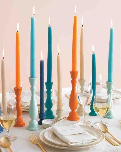 Try a modern twist at your Thanksgiving table with a variety of bright colors, like blues and warm orange tones! Colored Candlesticks, Colorful Candle Holders, Affordable Wedding Centerpieces, Modern Thanksgiving, Wedding Ceremony Ideas, Coloured Candles, Painted Candles, Wedding Centerpieces Diy, Martha Stewart Weddings