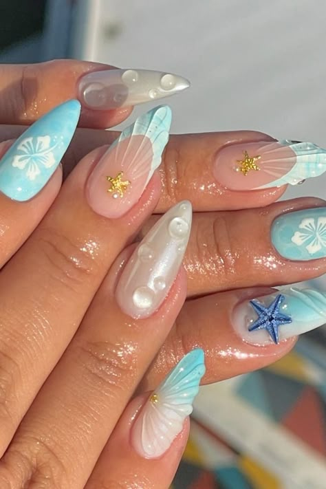 Let your inner Ariel burst free with these absolutely stunning ocean nail ideas. These are cute mermaid nails that bring the beauty of the ocean to your fingertips. Beach nails you won't be ab;r to get over! Ongles Baby Blue, Beach Themed Nails, Seashell Nails, Mermaid Nail Art, Mermaid Nail, Beachy Nails, Summer Nails Beach, Baby Blue Nails, Nagellack Trends