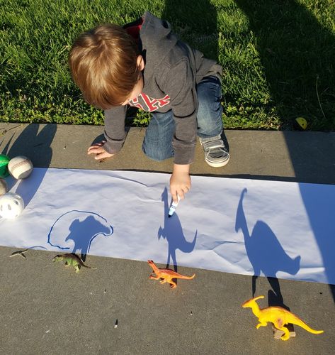 By far my favorite outdoor preschool activity. Shadow tracing with dinosaurs. This was so fun and my 3 year old loved it!! Dinosaurs Arts And Crafts For Preschoolers, Dino Day Preschool, Dinosaur Outdoor Activities Preschool, Dinosaur Outside Activities, Outdoor Activities For 3-5, Outdoor Art Activities For Preschool, Dinosaur Nature Activities, Preschool Dinosaur Activities Art, Hand Print Activity For Preschool