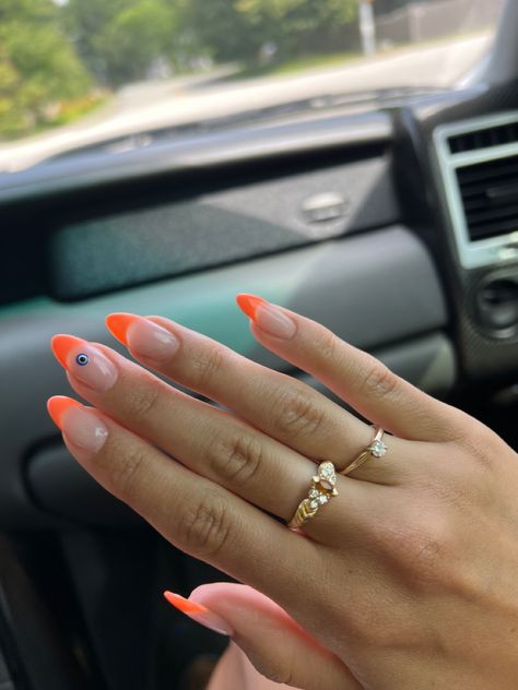 orange tips on almond shape acrylics with evil eye on middle finger nail. gold rings Nail Ideas Evil Eye Pink, Orange Evil Eye Nails, Neon Orange Nails, Pink French Nails, Evil Eye Nails, Turkish Eye, Holiday Nail Designs, Summery Nails, Orange Nails