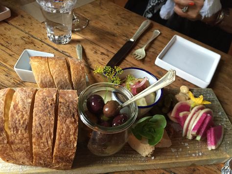 Bread, olives, and other pre-dinner nibbles served at The Lost Kitchen in Freedom, Maine, in 2016. Rendezvous Aesthetic, Rhode Island Clam Chowder, Pub Aesthetic, Erin French, Searsport Maine, Lost Kitchen, Meat And Cheese Board, Dinner Club, French Recipes