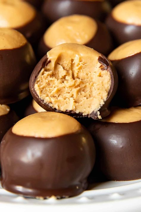 These buckeye balls are a sweet creamy rich peanut butter ball dipped in dark chocolate to form a hard exterior. They are the best ever. This no bake recipe is so yummy, eating one just won't be enough! Buckeye Balls Recipe, Chocolate Covered Peanut Butter Balls, Peanut Butter Ball, Peanut Butter Slice, Peanut Butter Balls Easy, Chocolate Peanut Butter Balls, Buckeye Balls, Cooking With Karli, Peanut Butter Balls Recipe