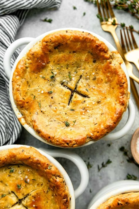 The classic comfort food dinner recipe, made mini: Individual Chicken Pot Pie! A creamy pot pie filling with tender chicken & hearty vegetables is individually portioned & topped with homemade all-butter pot pie crust studded with fresh herbs for extra savory flavor. Bake until the pastry is flaky & golden for a super cozy dinner. Great for date night or any chilly winter evening! (Easy make-ahead instructions provided.) #chickenpotpie #potpiecrust #individualchickenpotpies #minichickenpotpies Creamy Pot Pie, Pot Pie Crust, Pie Night, Winter Comfort Food Recipes, Individual Chicken Pot Pies, Herbed Butter, Mini Pot Pies, Chicken Pot Pie Filling, Mini Chicken Pot Pies