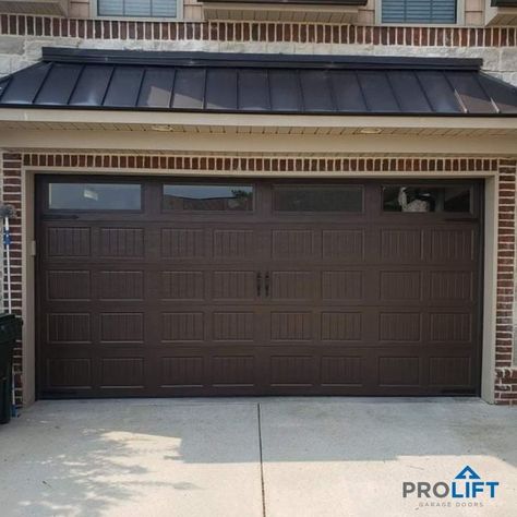 Dark brown double garage door with grooved panels, windows and decorative hardware by ProLift Garage Doors of Chattanooga Brown Garage Door, Contemporary Garage Doors, Garage Door Colors, Carriage House Garage Doors, Double Garage Door, Garage Door House, Garage Door Paint, Carriage Garage Doors, Dark Doors