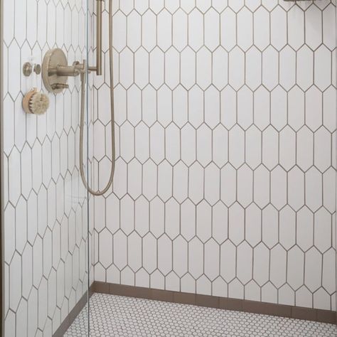 Recreate this fabulous shower for your new bathroom remodel.  It's comprised of three patterns and the brown subway it the frame where the elongated hex tile meets the penny round tile.   Please see the carousel for closeups of the three tile design that make up this shower.  
This shower inspiration is part of the Bathroom in a Box Crewe Design Collection.  The rest of the products to complete the bathroom remodel are shown with links on where to purchase. Penny Stone Tile Bathroom, Penny Tile In Bathroom, Penny Round Bathroom Floor, Penny Round Tile Bathroom Floor, Picket Tile Bathroom, Penny Round Tile Bathroom, Tile In Bathroom, Picket Tile, Stone Tile Bathroom