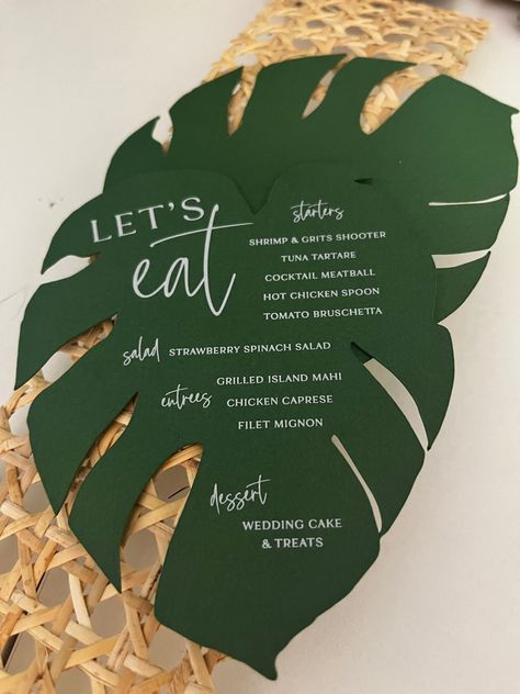 Calling all tropical plant lovers 🌴:These monstera menus are the coolest element you can add to any events table! Pairs nicely with a colorful napkin and is bound to make your guest excited to eat! 🪴💗🙌🏽   #wilmingtonnc #customweddinginvitations #custominvitations #weddingdetails #weddingdesign #stationerydesign #weddingstationery #weddingplanning #weddinginspiration #weddinginspo #weddingideas #stationery #weddingdecor #modernwedding Wedding Invitations Tropical Theme, Tropical Wedding Stationery, Tropical Menu Design, Monstera Wedding, Menu Table, Tropical Wedding Theme, Hawaii Theme, Thailand Beach, Tropical Food