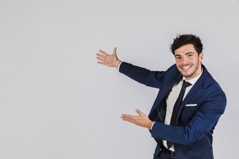 Happy portrait of a young businessman giving presentation against grey background | Premium Photo #Freepik #photo #background #business #invitation #people Happy Portrait, Workplace Quotes, Close Up Portraits, Poster Background Design, 웃긴 사진, Business Infographic, Body Poses, Gray Background, Free Photo