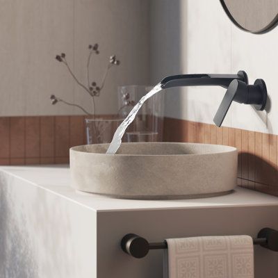 Influenced by modern home decor trends, wall-mounted faucets fit perfectly into the minimalist style. It not only saves space, but also brings a touch of modern elegance to the bathroom. The waterfall spout design on the upper opening allows you to clearly see every drop of water flowing out. Feel the collision with nature. All in all, just a great recommended product to decorate your bathroom. Finish: Black | Tomfaucet Wall Mounted Bathroom Faucet in Black | 9.2 H x 6.3 W x 2.76 D in | Wayfair Wall Faucet Bathroom, Modern Half Bathroom, Bathroom Interior Design Wood, Bathroom Wall Faucets, Midcentury Lighting, Waterfall Sink Faucet, Bathroom Faucets Black, Wall Mounted Bathroom Faucet, Wall Mount Faucet Bathroom Sink