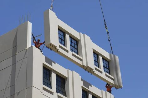 An exterior wall panel, manufactured by Clark Pacific, is positioned into place. Image: Clark Pacific Exterior Wall Panels, Robie House, Lake Flato, Townhouse Exterior, Modular Housing, Seattle Hotels, Facade Panel, Build Your House, Construction Waste