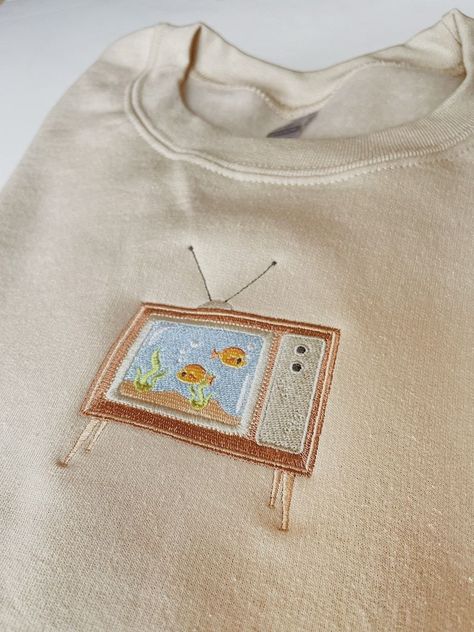 Embroidered Aquarium TV Sweatshirt

Cozy up in this embroidered sweatshirt featuring a colorful aquarium TV. Perfect for lounging around the house or running errands. Find it on now! #embroidery #sweatshirt #aquarium . #Upcycling #Machine_Embroidery_Designs_Sweatshirt #Simple_Shirt_Embroidery #Fall_Sweatshirt_Ideas Embroidered Clothes Ideas, Hoodie Embroidery Ideas, Sweatshirt Embroidery Ideas, Shirt Embroidery Ideas, Cali Fits, Sweatshirts Ideas, Embroidery Crewneck, Diy Sweatshirt, Embroidery On Clothes