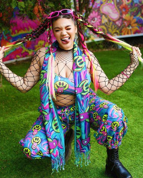 Put on the Happy Hour Set and instantly feel the night come alive! This multicolored set has a comfortable fit, and a crazy good UV-reactive print that produces a euphoric neon glow under festival lights. #ravesets #raveoutfit #festivaloutfit #electricdaisycarnival #electriclove #trippy #trippyoutfits #electriclove #iheartraves #uvreactive Basic Baddie Outfits, Bonnaroo Fashion, Neon Rave Outfits, Bonnaroo Outfits, Glow Outfits, Neon Carnival, Trippy Clothes, Rave Aesthetic, Rave Outfits Edc