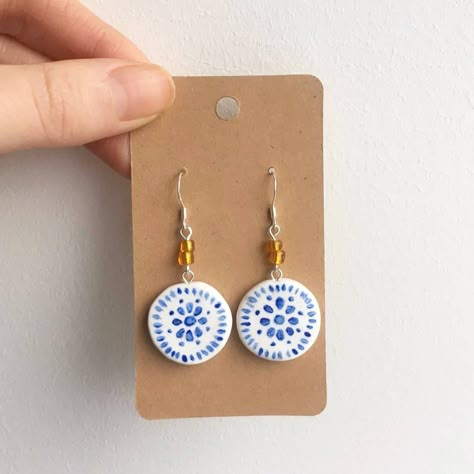 these pretty earrings are handpainted on polymer clay bases <3 they are inspired by the beautiful blue and white tiles we've seen !  they are glazed with a polyurethane varnish to protect them and give them a little shine :) since these are hand painted, there will of course be slight differences between them ! Blue And White Tiles, White Porcelain Tile, Handmade Ceramic Jewelry, Blue White Porcelain, Porcelain Earrings, Painted Earrings, Earrings Summer, Ceramic Earring, Summer Earrings