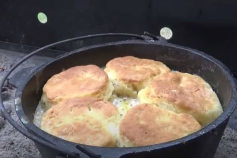 Make delicious Dutch oven biscuits and sausage gravy over a campfire. They're easy and delicious and everything cooks in one vessel. Dutch Oven Biscuits Camping, Biscuits In A Dutch Oven, Dutch Oven Biscuits And Gravy Camping, Dutch Oven Biscuits And Gravy, Campfire Biscuits And Gravy, Dutch Oven Cornbread, Dutch Oven Biscuits, Campfire Biscuits, Dutch Oven Breakfast