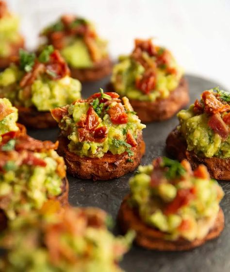 These mini sweet potato bites are served with a bacon and sun dried tomato guacamole. They're easy to make, perfect for a party and BURSTING with flavour! #guac #bacon #sweetpotato #fingerfood #appetizer | www.dontgobaconmyheart.co.uk Potato Nibbles Recipe, Sweet Potato Canapes, Sweet Canapes, Finger Food For Party, Hangover Brunch, Christmas Tapas, Sweet Potato Appetizers, Sweet Potato Bites, Guacamole Bites