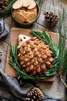 Woodland Hedgehog Cheese Ball: a simple, savory appetizer that will be a stunning centerpiece at a woodland baby shower or first birthday. Cream cheese, cheddar, Worcestershire sauce, and spices make this vegetarian snack idea a super cute, gender neutral munchie. | www.savortheflavour.com #woodland #babyshower #firstbirthday #hedgehog #cheeseball Hedgehog Cheese Ball, Woodland Baby Shower Food, Baby Shower Appetizers, Woodland Hedgehog, Shower Appetizers, Woodland Baby Shower Decorations, Forest Baby Showers, Baby Shower Woodland Theme