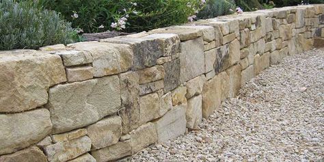 Retaining Wall Stone Ideas, Natural Stone Retaining Wall Landscape, Terraced Stone Retaining Wall, Natural Looking Retaining Walls, Stone Wall Exterior Landscaping, Short Stone Wall Around Patio, Stone Retaining Wall Driveway, Barnstone Retaining Wall, Natural Stone Garden Wall