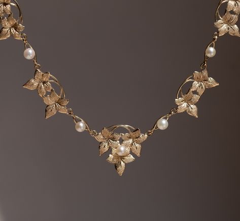 The Golden Eden Necklace 🦢 This dainty yet beautiful vintage Art Nouveau-style floral necklace is truly a rare find. Its intricately detailed flowers & vines alternates between small white pearls. This necklace is the perfect statement piece either worn stand-alone or featured in a layered necklace stack. #vintagenecklace #artnouveau #goldjewelry #uniquenecklace #goldnecklace #vintagejewelry Dainty Vintage Jewelry, Vintage White Gold Necklace, Art Nouveau Necklace, Vine Jewelry, Nigerian Recipes, Flowers Vines, Art Nouveau Necklaces, Gold Jewels Design, Gold Pearl Jewelry