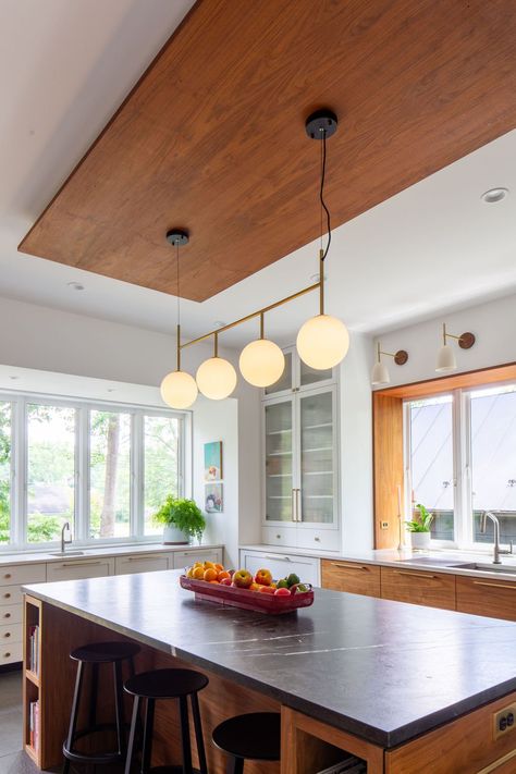 Walnut and black quartzite kitchen island with suspended walnut ceiling panel above. Quartzite Island, Quartzite Kitchen Island, Black Quartzite, Suspended Ceiling Panel, Walnut Ceiling, Drop Down Ceiling, Green Mosaic Tile, Quartzite Kitchen, Walnut Accents