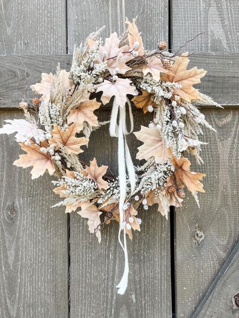 Neutral colored fall leaf wreath with pine cones, pampas, and berries. This lovely natural looking faux wreath includes high quality realistic elements that feel like it was gathered on a walk in the woods.   Autumn cream and browns will add eye catching beauty to your front porch or indoor spaces.  Wreath measures approximately 22"  Your wreath will be carefully packaged and attached to bottom of box with ties. Simply untie and remove. It is our highest priority to provide lovely, high quality, and natural looking decor. If there is a problem with your order please let us know so we can take the opportunity to make it right. Thank you for trying out our shop. Fall Leaves Decor, Brown Wreath, Fall Leaf Wreath, Woods Autumn, Fall Leaves Wreath, Pampas Grass Wreath, Faux Wreath, Boho Fall Decor, Fall Leaf Decor