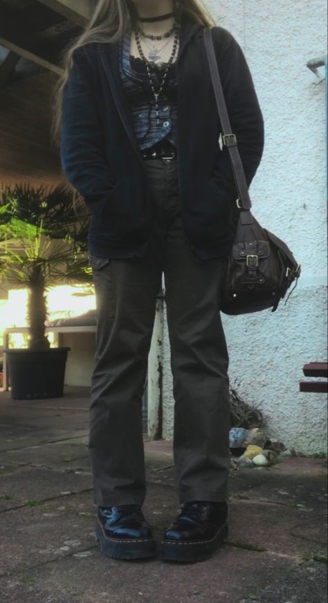 A mid-size person/girl wearing a thrifted tight grey waistcoat, a black lace tank top under it, wide dark olive green cargo pants, black platform dr. Martens and multiple crystal rings and bracelets. 	The person is also wearing multiple silver necklaces, one in form of a green crystal and another in form of a fairy  necklace, a black rosary-style bead necklace, a butterfly and a black lace choker. Wide Leg Grunge Outfit, Two Toned Pants Outfits, Fairy Grunge Cargo Pants, Cold Tone Outfit, Doc Martens With Cargo Pants, Grunge Winter Outfits Plus Size, Green Cargo Outfit Aesthetic, Fairy Grunge Pants Outfit, Winter Outfits Fairy Grunge