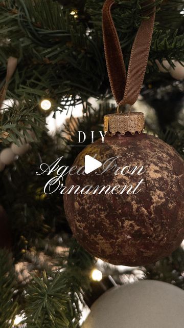 Amanda West on Instagram: "DIY aged Iron Christmas ornaments #ad   1. Grab some plastic ornaments, skewers and floral foam from your local craft store.  2. Spray wall texture on it and let it dry for about 5-10 minutes then start smoothing some of the big chicks out with a foam brush.  3. Once fully dry, grab your @handypaintpail craft tray and add desired paint colors into it. Brush one layer of paint on the ornament and let it dry  4. When dry, go  in with your second color with a sponge and do dabbing motions with it all over the ornament. Let dry.  5. Add some rub in buff with a sponge all over the ornament until you get the desired look you’re going for.  6. Last, brush on the Rub n Buff on the tops and add a new ribbon!   What do y’all think!? Tag me if you make them!  #handypaintpai Spray Painted Ornaments, Christmas Plastic Ornaments Diy, Diy Copper Ornaments, Spray Painting Ornaments, Spray Painting Christmas Ornaments, Diy Feather Ornaments, Textured Ornaments Diy, Hand Painted Ornaments Glass Ball Diy, Rub N Buff Christmas Ornaments