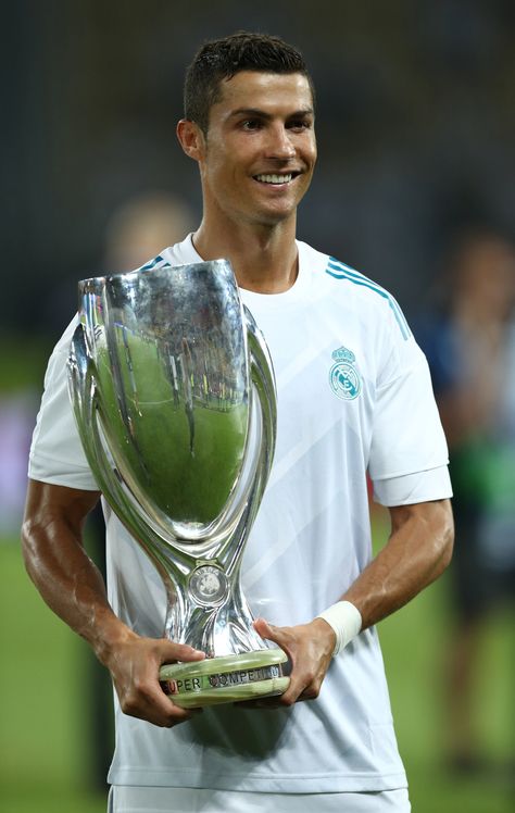 Cristiano Ronaldo poses with the 2017 UEFA Super Cup trophy | August 8, 2017 Uefa Super Cup, Most Hated, Gym Guys, Cristiano Ronaldo Cr7, August 8, Simple Image, Cristiano Ronaldo, The King, Real Madrid