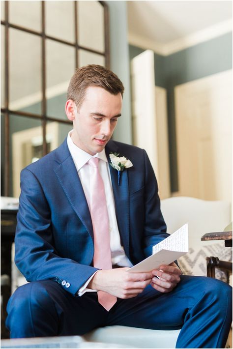 Groom with blue suit and pink tie Dark Blue Suit With Pink Tie, Pink And Blue Groomsmen Attire, Navy Suit Pink Tie, Blue And Pink Groomsmen, Suit With Pink Tie, Groom Blue Suit Pink Tie, Blue Suit Pink Tie, White Flower Boutonniere, May Wedding Colors