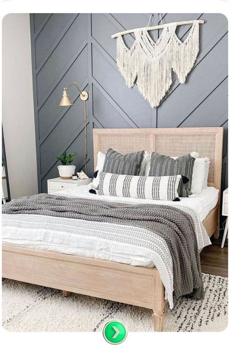 Chevron-patterned dark accent wall blends boho and modern styles in the bedroom, adding a dynamic, trendy touch that works well with a variety of textures and decor elements. Scandinavian Bedroom Accent Wall, Bedroom Slate Wall, Accent Wall Bedroom Wood Panel, Bedrooms With Paneling, Accent Behind Bed, Black Wood Accent Wall Bedroom, Accent Wall Slanted Ceiling, Primary Bedroom Accent Wall Ideas, White Bedroom Accent Wall