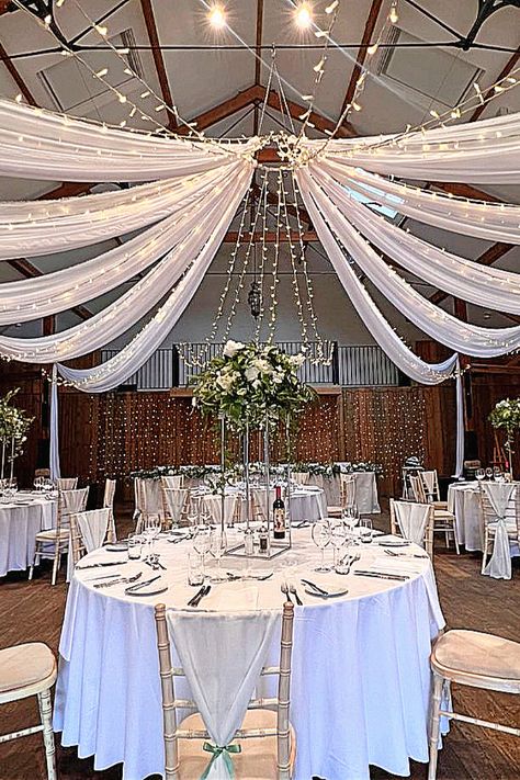 Here’s a stunning draped ceiling and twinkling lights for your big day.#WeddingInspo #CeilingDraping #EventLighting Draped Ceiling, Ceiling Fabric, Modern Wedding Theme, Draping Wedding, Ceiling Draping, Reception Backdrop, Garden Pathways, Enchanted Wedding, Wedding Lighting