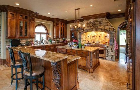 Mediterranean kitchen with stone oven surround and decorative wood cabinets Tuscan Kitchen Design Tuscany, Tuscan Kitchen Ideas Rustic Italian, Tuscan Kitchen Colors, Tuscany Kitchen, Style Toscan, Tuscan Kitchen Design, Tuscan Decorating Kitchen, Old World Kitchens, Kitchen Cost