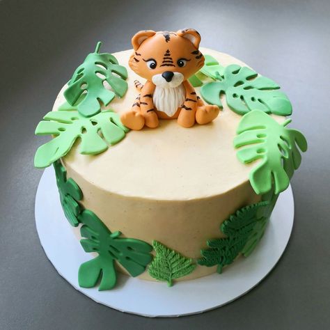 Red velvet sponge layered with mascarpone Swiss meringue buttercream. Decorated with baby tiger and leaves in modelling paste. Leaves Birthday Cake, Tiger First Birthday Party, Tiger Baby Shower Theme, Tiger Smash Cake, White Tiger Birthday Cake, Tiger Themed Birthday Party, Tiger Cake Ideas, Tiger Cakes For Kids, Tiger Birthday Party Ideas