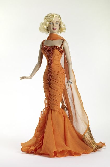 THE FASHION DOLL REVIEW: Tonner Doll to release additional Marilyn Monroe items Mariyln Monroe Dresses, Marilyn Monroe Orange Dress, Marlyne Monro Orange Dress, Marlyne Monro In Pink Dress, Marilyn Monroe Skirt Blowing, Hollywood Glamour Dress, Marilyn Monroe Barbie Dolls, History Fashion, Iconic Dresses