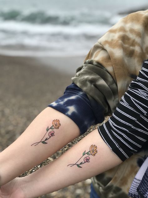 Mother daughter matching tattoos. Both of our birth month flowers intertwined 🥰. #tattoo #tattooideas #diy #mother #daughter #motherdaughter #bestfriends #duo #matchingtattoos #beach #flowertattoos #flowers #love Subtle Mother Daughter Tattoos, Minimalist Mother Daughter Tattoo, Mother Daughter Birth Flower Tattoos, Flowers Intertwined Tattoo, Flower Tattoo Matching, Mother Daughter Matching Tattoos, Intertwined Tattoo, Flowers Intertwined, Bestie Tattoos