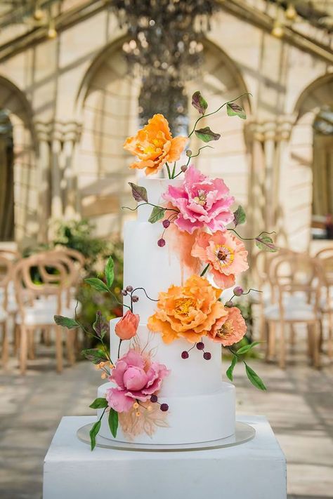 White iced wedding cake decorated with pink and orange flower decorations | Alexander Smith Stories | Pink Orange Wedding Flowers, Pink Orange Wedding, Iced Wedding Cake, Minimalist Wedding Cake, Wedding Cake Pink, Wedding Cake With Pink, Summer Wedding Cakes, Orange Wedding Flowers, Colorful Wedding Flowers