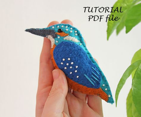 "DIGITAL PDF file TUTORIAL In this pattern I use blanket stitch and satin stich. There is a lot of information on the Internet and on YouTube how to make these types of stitches. I don't teach stitches in this tutorial. This felt sewing pattern \"Kingfisher\" includes: - a description 22 illustrated step by step instructions with detailed texts and photos - Pattern ready to print. - List of materials and tools Skill level: Beginner/Intermediate (only basic sewing skills is needed). Language: Eng Felt Embroidery Animals, Applique Birds Pattern, Felt Kingfisher, Bird Sewing Pattern, Felt Bird Ornaments, Easy Beading Tutorials, Felt Birds Ornaments, Felt Sewing, Beaded Jewelry Pattern