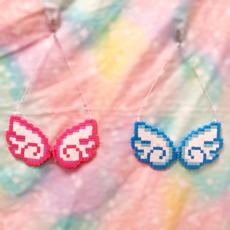 Two chibi Angel wings necklaces made out of peeler beads.  One is pink and the other is blue. Kawaii Perler, Chibi Angel, Pastel Gore, Perler Beads Ideas, Melt Beads Patterns, Kandi Inspo, Hamma Beads Ideas, Easy Perler Bead Patterns, Perler Creations