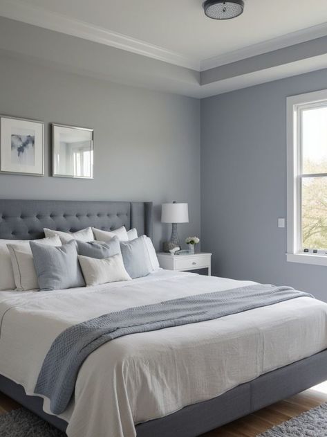 Create a soothing atmosphere with a blue-gray accent wall in your bedroom. Complement it with crisp white bedding, a mirror with a wooden frame, and a soft gray area rug for a modern and elegant look. Gray Accent Wall Bedroom, Gray Accent Wall, Bedroom Wall Colour Combination, Modern Bedroom Colors, Comfortable Bedroom Decor, Beautiful Bedroom Colors, Blue Bedroom Walls, Best Bedroom Colors, Wall Color Combination