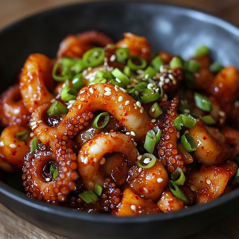 🐙 Nakji Bokkeum (Spicy Stir-Fried Octopus): Experience bold, spicy flavors in every bite! 🌶️ #KoreanFood #SpicyDish Nakji Bokkeum (Spicy Stir-Fried Octopus) Ingredients: Octopus (1 lb, cleaned and cut) Gochujang (2 tbsp) Soy sauce (2 tbsp) Sugar (1 tbsp) Garlic (3 cloves, minced) Onion (1, sliced) Green onions (2, chopped) Sesame oil (1 tsp) Sesame seeds (for garnish) Instructions: Mix gochujang, soy sauce, sugar, and garlic in a bowl. Heat oil in a pan and sauté onions until soft. Add oc... Nakji Bokkeum, Octopus Dishes, Octopus Food, Fried Octopus, Sauté Onions, Noodle Art, Squid Recipes, Plating Ideas, Instagram Recipes