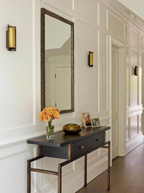 Painted wood panelled hallway with bronze & smoked oak console, brass and bronze wall lights and mirror. Panelled Hallway, Black And White Hallway, Hallway Panelling, Victorian Villa, Entrance Hall Decor, White Hallway, Hallway Wall Lights, Painting Wood Paneling, Hallway Mirror