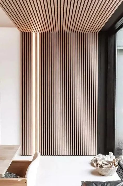 a minimalist space with a wooden slat accent wall that extends up the ceiling and built in lights right in this wall Slat Wall Stairwell, Wooden Slat Bedroom, Wood Slat Entryway, Wood Slats Ceiling, Slat Wall Corner, Wall Slats Decor, Slat Accent Wall, Slat Ceiling, Wood Slat Ceiling