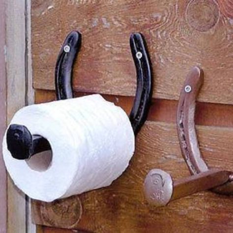 This toilet paper holder is great addition to your rustic bathroom. Made with a genuine railroad spike and horseshoe. Comes with two pre-drilled holes for easy mounting. Also, have an option to purchase horseshoe nails with it (This option comes with the Natural Metal color). Otherwise, you can also choose a color of your choice. Dimensions: 5" wide x 5" tall x 7" from the wall Materials: steel, metal, iron Diy Toilet Paper Holder, Rustic Toilet Paper Holders, Toilet Paper Holder Wall Mount, Cool Welding Projects, Horseshoe Crafts Projects, Rustic Toilets, Toilet Paper Holder Wall, Welding Crafts, Horseshoe Projects