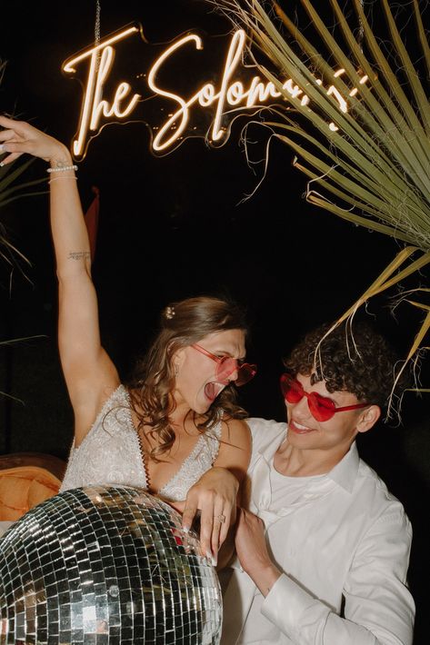 Bride and groom act excited at night reception. Tropical wedding theme inspo comes from the orange and pinks and the heart sunglasses the couple is wearing. Retro Disco Wedding Theme, Retro Glam Wedding, Disco Wedding Theme, Desert Disco, Tropical Desert, Tropical Wedding Theme, Bright Wedding Colors, Disco Wedding, Tropical Wedding Inspiration