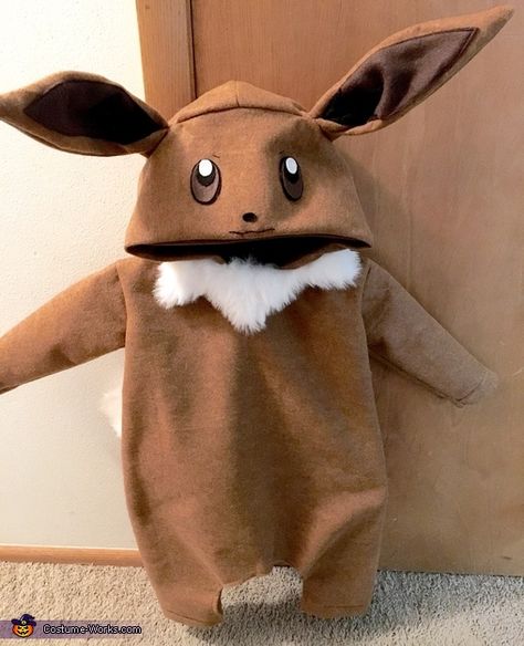 My favorite Pokémon, Eevee. I used felt and fur fabric as the materials in this costume. I used a random Halloween costume pattern to help guide for correct size and sewed as directed. For the tail, ears, and eyes, I eyeballed it's shapes measurements and attached... Photo 3 of 4. Pokemon Baby Clothes, Eevee Costume, Pokemon Costumes Diy, Grass Pokemon, Pokemon Halloween Costume, Pokémon Eevee, Halloween Costume Patterns, Baby Pokemon, Baby Cosplay