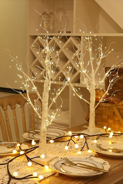 The silver birch branches, adorned with delicate twinkling lights and nestled amidst festive greenery, create a simple yet enchanting Christmas table centerpiece, exuding a touch of natural beauty and holiday warmth. This post contains an affiliate link which adds no cost to you. Twinkle Light Centerpiece, Wedding Indoor Decor, Branch Table Centerpieces, Led Birch Tree, Branch Lights, Christmas Table Centerpiece, Tree With Lights, Lighted Centerpieces, Wedding Indoor