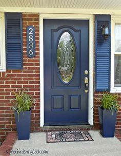 Add Great Curb Appeal to your Home with a Front Door Makeover.  A beautiful front door transforms the entry to your home, adds great appeal and gives a pop of color to an otherwise bland and boring entry.  This project for my front door makeover is one that I have been wanting to do for several seasons. My husband retired last June, and I finally can get his help on so many projects that I have ... Front Door For Beige House, Behr Blue Front Door Paint Colors, Blue Front Door With Red Brick, Sherwin Williams Naval Front Door, Blue Door Brick House, Dark Blue Front Door Colors, Dark Blue Shutters, Dark Blue Front Door, Blue Front Porch