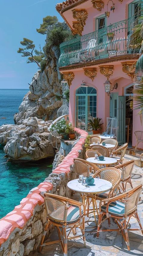 The image shows a beautiful outdoor dining area of a restaurant. The area is surrounded by a low wall and has a stunning view of the Mediterranean Sea. The tables and chairs are made of wicker and there are colorful flowers on each table. The restaurant is located in a small town on the Amalfi Coast in Italy. Amalfi Coast Restaurants, Almafi Coast Italy, Amalfi Coast Towns, Italy Restaurant, Italian Bistro, Palm Springs Home, Italy House, Dreamy Places, Italian Aesthetic